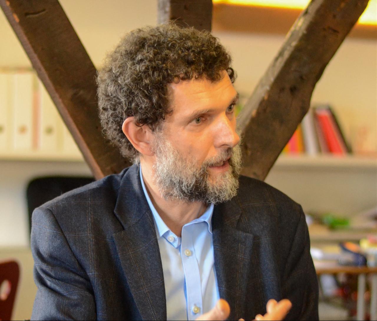 Parisian-born Turkish philanthropist Osman Kavala speaking in his office at the Depo arts centre in Istanbul's Tophane district. (Photo by Anadolu Kultur/HO/AFP)