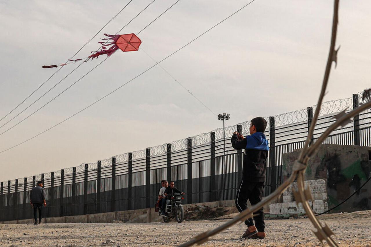 Gaza parents warn children off kites as Israel expands attacks