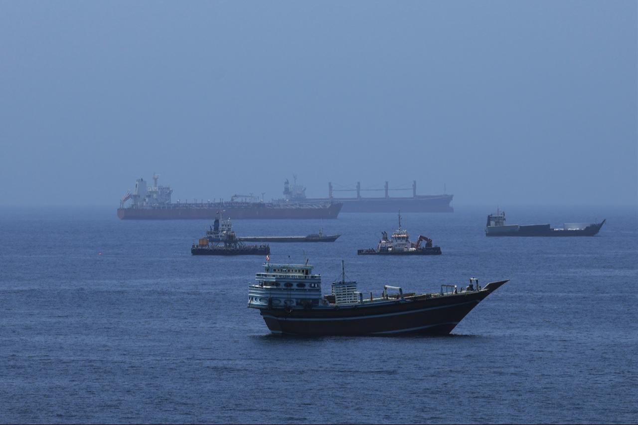 A view of commercial cargo vessels and crude oil tankers are anchored in the Gulf of Oman, off the coast of Muscat, Oman, on June 21, 2026, as they prepare to transit through the critical Strait of Hormuz. (AA Photo)