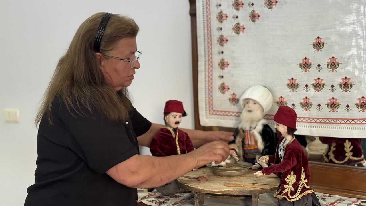 Nazike Kaban Gunduz poses next to her doll art. (AA Photo)
