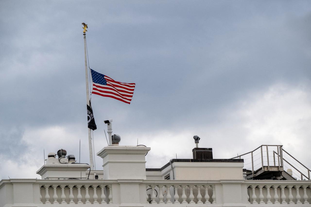 The US flag is flown at half-staff, while a red-tailed hawk sits atop the flag pole, at the White House in Washington, DC, on August 25, 2026. US President Donald Trump ordered flags to be flown at half-staff until sunset on September 1, 2026, to honor the life and legacy of entertainer and philanthropist Dolly Parton, who passed away at age 80. (AFP Photo)