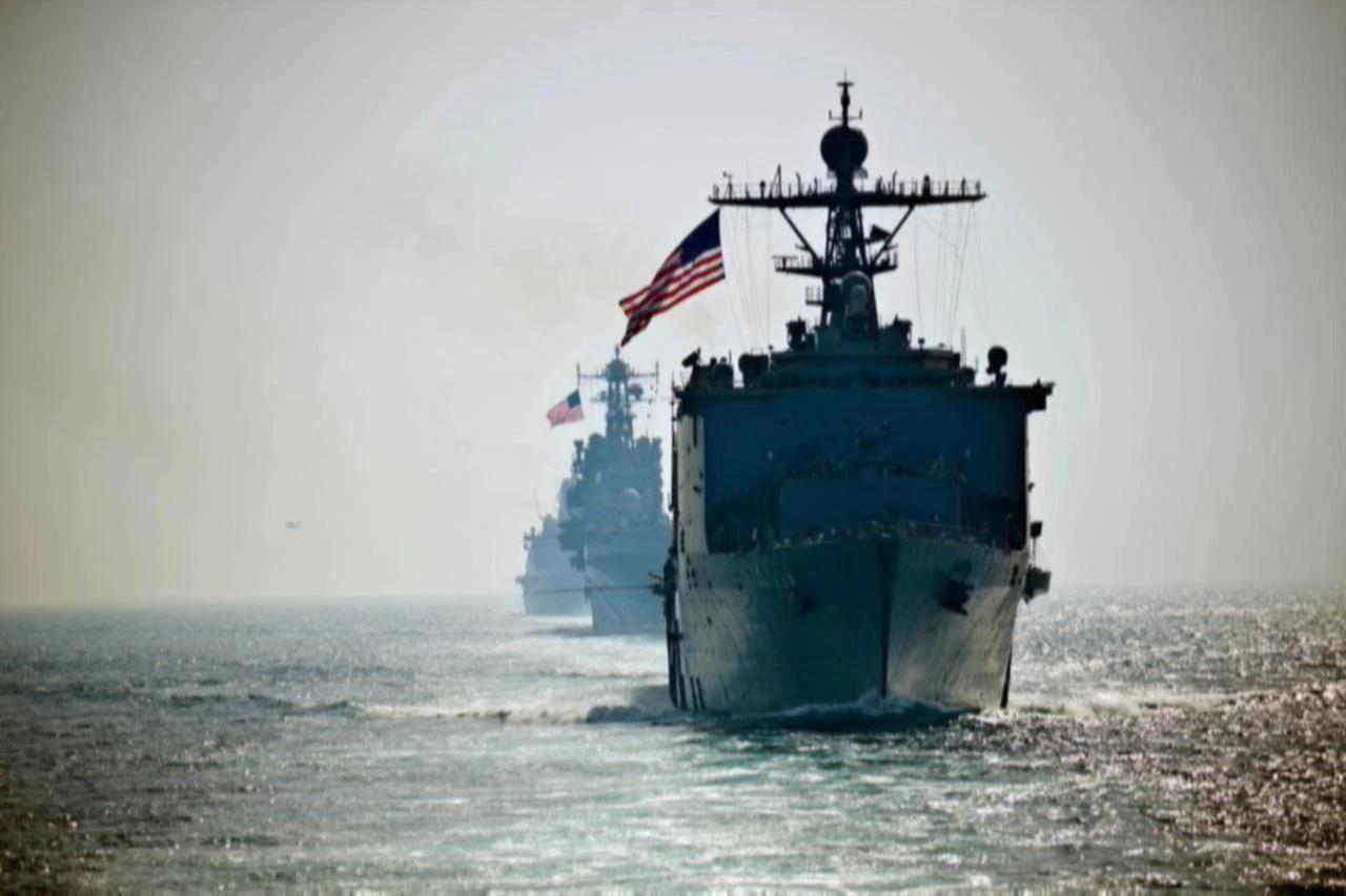 The amphibious dock landing ship USS Rushmore leads the amphibious assault ship USS Peleliu as they transit the Strait of Hormuz while deployed in the U.S. 5th Fleet area of operations. (U.S. Navy Photo)