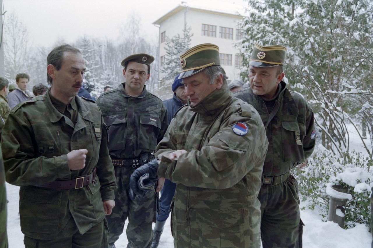 Ratko Mladic (2R) checks his watch at the Lukavica barracks in the surburbs of Sarajevo on February 15, 1994. (AFP File Photo)