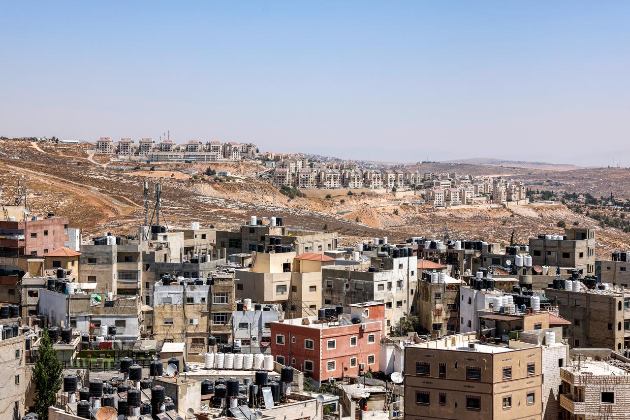 A view shows the Qalandia refugee camp in the foreground, with the Israeli settlement of Kokhav Ya’akov in the background, south of the West Bank city of Ramallah, Aug. 25, 2026. (AFP Photo)