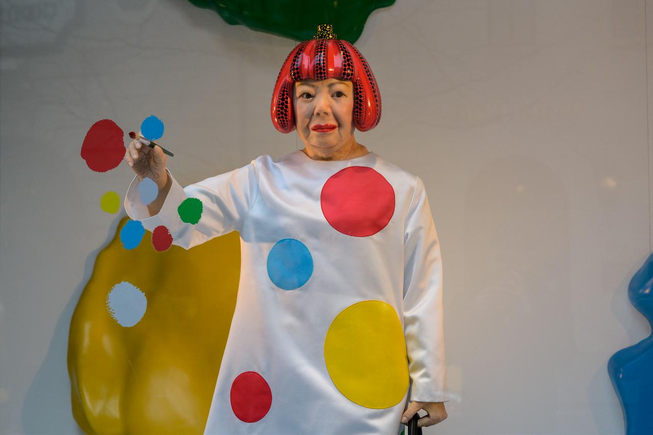 A life-like robot of artist Yayoi Kusama painting a window stands at the Louis Vuitton store on Fifth Avenue in New York City, U.S., Jan. 13, 2023. (AFP Photo)