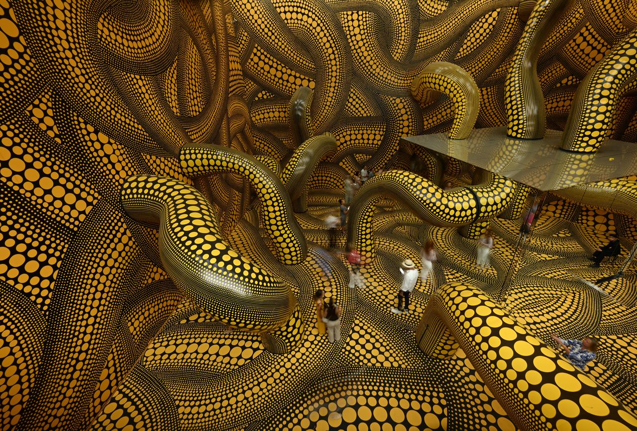 Visitors walk through the installation "Infinity Mirrored Room – The Hope of the Polka Dots Buried in Infinity Will Eternally Cover the Universe" by Japanese artist Yayoi Kusama at the Museum Ludwig in Cologne, western Germany, Aug. 2, 2026. (AFP Photo)
