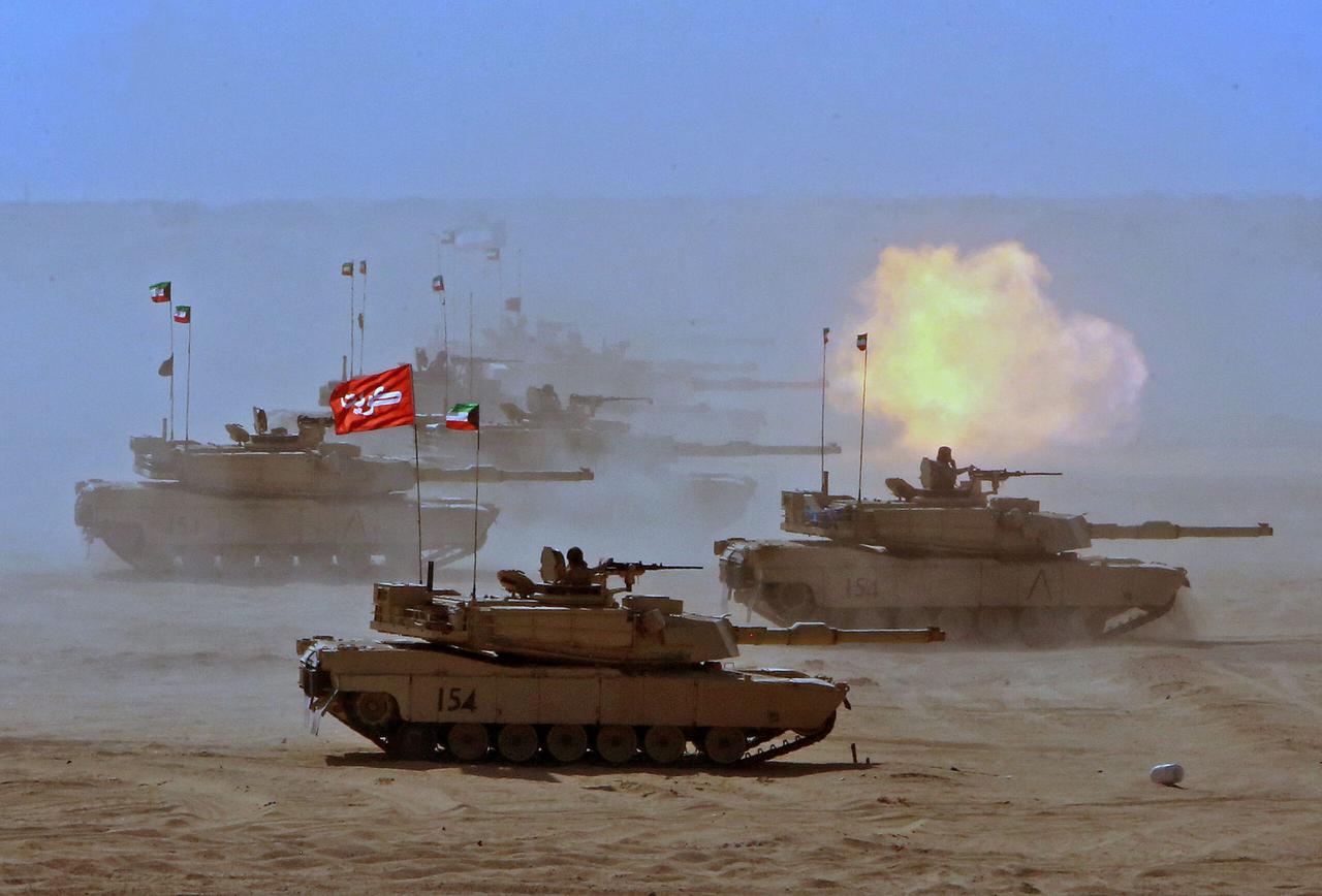 Tanks from the Kuwaiti Land Force fire during a military exercise at the Udaira military range, about 140km north of Kuwait City, on November 18, 2021. (AFP Photo)