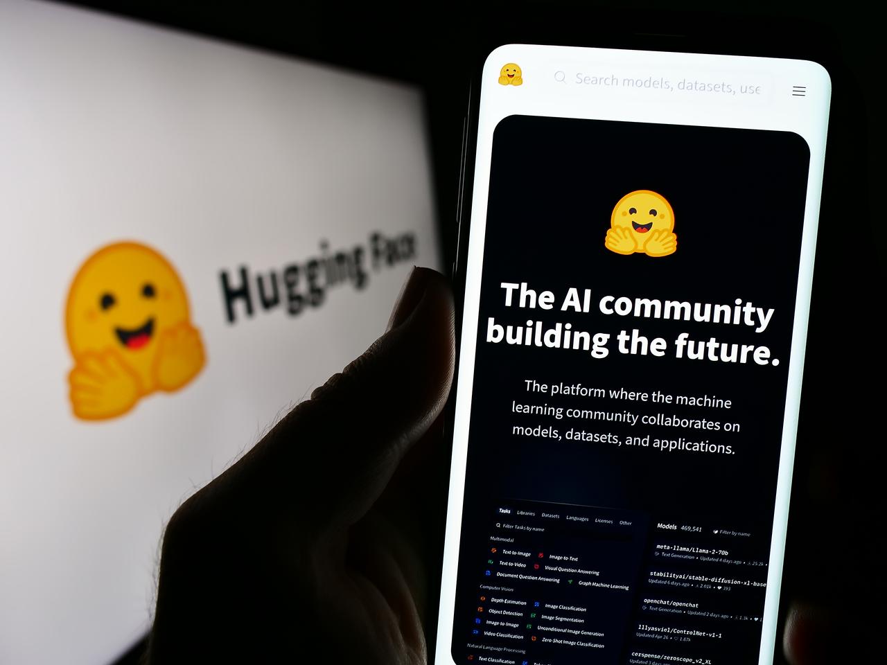 A smartphone displays the Hugging Face website, an online platform for AI models, datasets and machine learning tools. (Adobe Stock Photo)