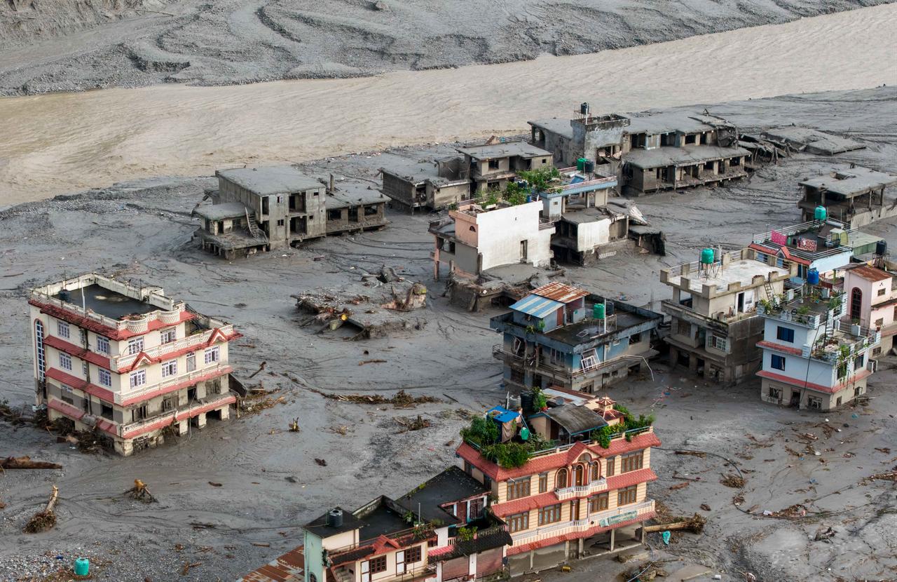 An aerial view shows houses lying deluged in sludge after flash floods at Devighat, Bidur Municipality in Nepal's Nuwakot district, August 27, 2026. (AFP Photo)