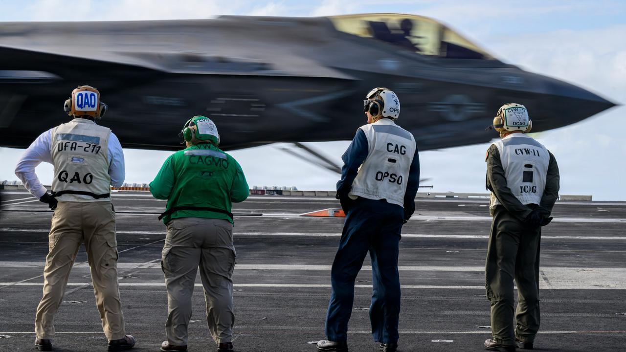 U.S. Navy Sailors observe the landing of an F-35C Lightning II on the flight deck of Nimitz-class aircraft carrier USS Theodore Roosevelt (CVN 71) during Exercise Rim of the Pacific (RIMPAC), July 25, 2026. (Photo via U.S. Navy)