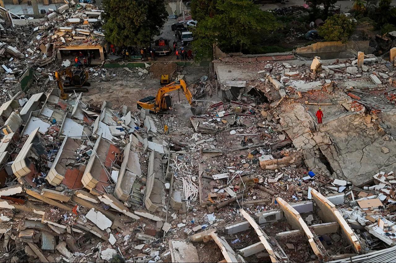 This aerial picture shows a backhoe loader working at the site of buildings destroyed during the June 24 twin earthquakes, in Caraballeda, La Guaira State, Venezuela, June 29, 2026. (AFP Photo)