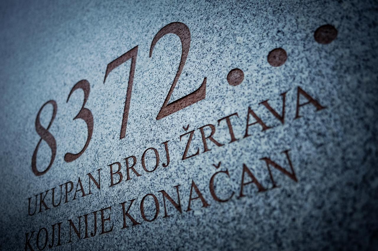 This photograph shows a monument bearing the inscription "8372 — the total number of victims, which is not final" at the memorial cemetery in the village of Potocari, near the eastern Bosnian town of Srebrenica, on August 27, 2026. (AFP Photo)
