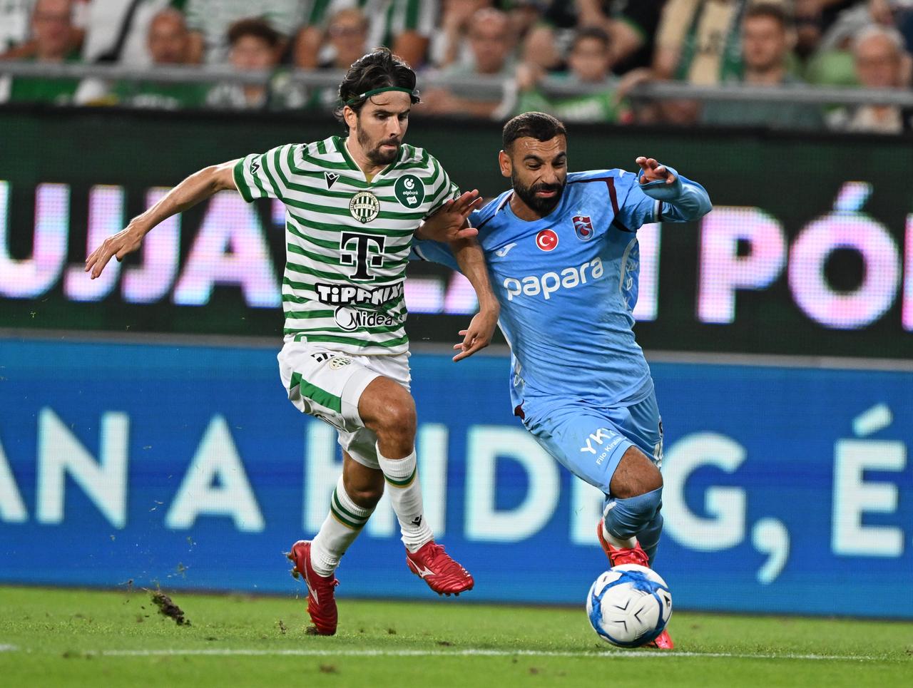 Trabzonspor player Muhammed Salah (right) battling an opponent during a match against  Hungary’s Ferencvaros. (AA Photo)