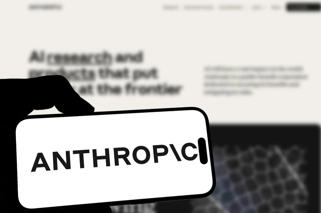 Anthropic logo appears in front of a screen. (Adobe Stock Photo)