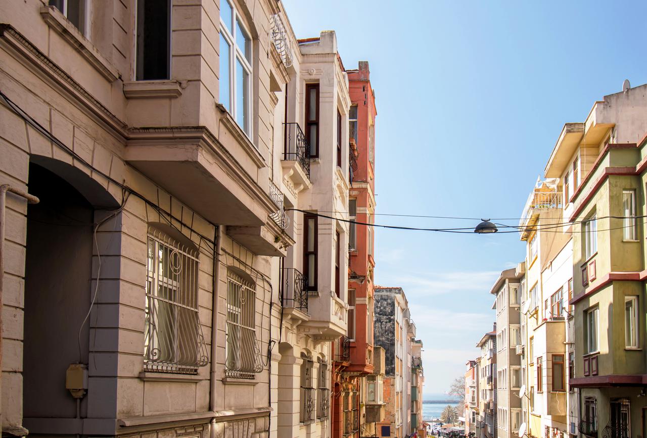 Residential buildings line a street in the Yeldegirmeni neighborhood of Kadıkoy, Istanbul, Türkiye, (Adobe Stock Photo)