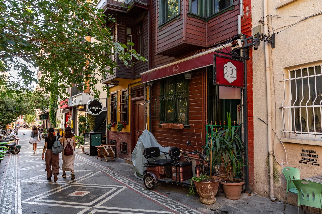 People walk past cafés and historic buildings in the Yeldegirmeni neighborhood of Kadıkoy, Istanbul, Türkiye. (Adobe Stock Photo)