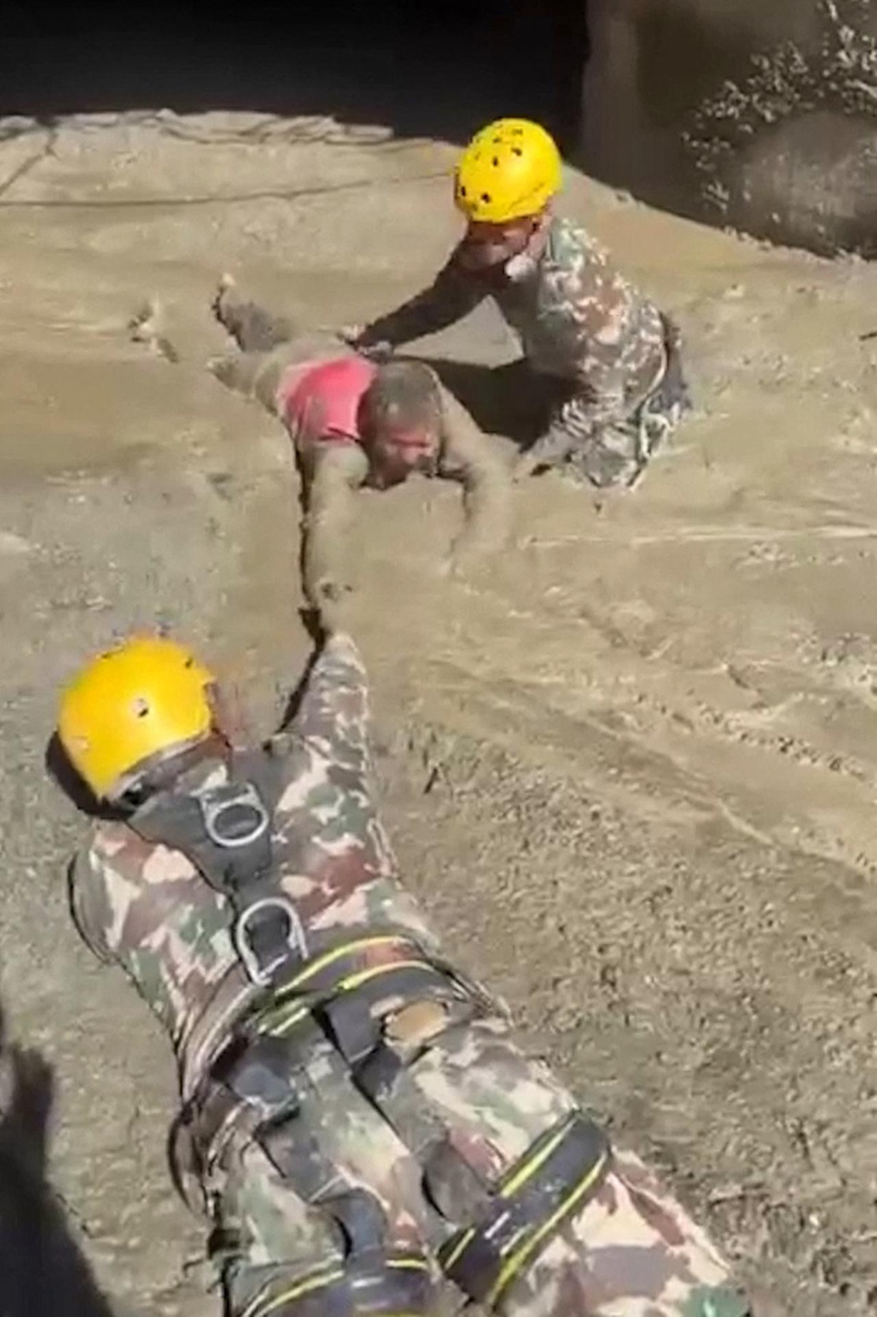 Screen grab picture shows the Nepali Army rescuing a person trapped inside a tunnel at a hydropower project. (AFP Photo)