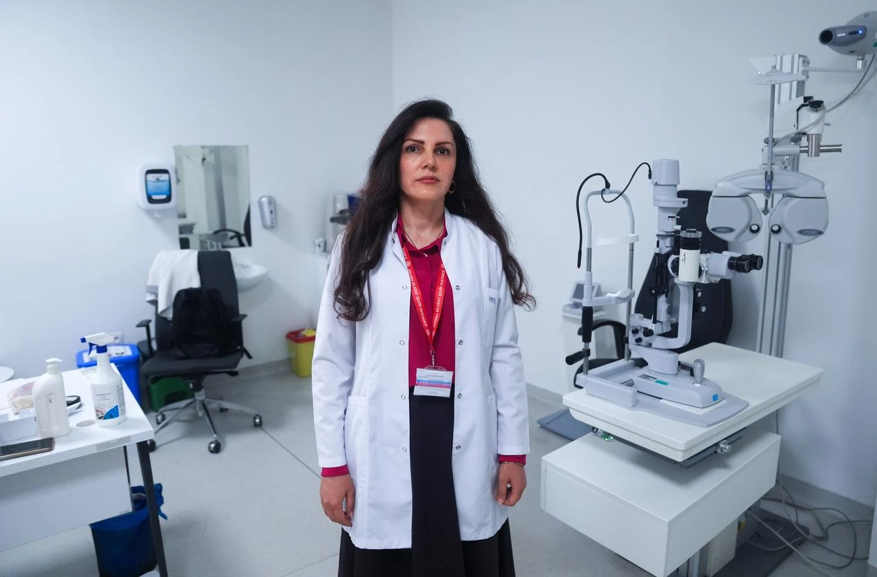 Assoc. Prof. Cigdem Coskun, an ophthalmology specialist at Bilkent City Hospital, poses inside an eye examination room in Ankara, Türkiye. (AA Photo)