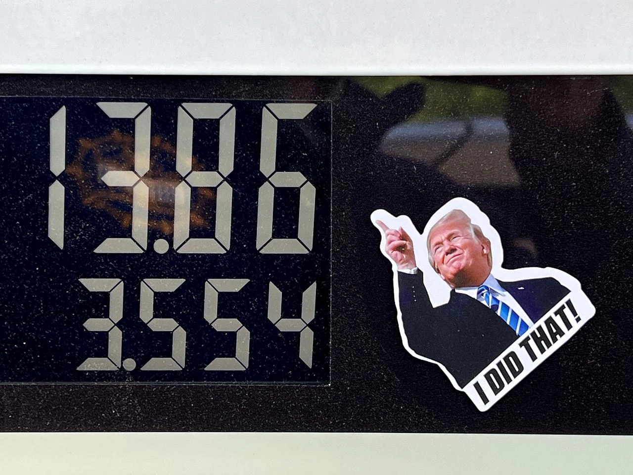 A sticker with the image of U.S. President Donald Trump is adhered to a pump at a BP gas station in Asheville, North Carolina on April 17, 2026. (AFP Photo)