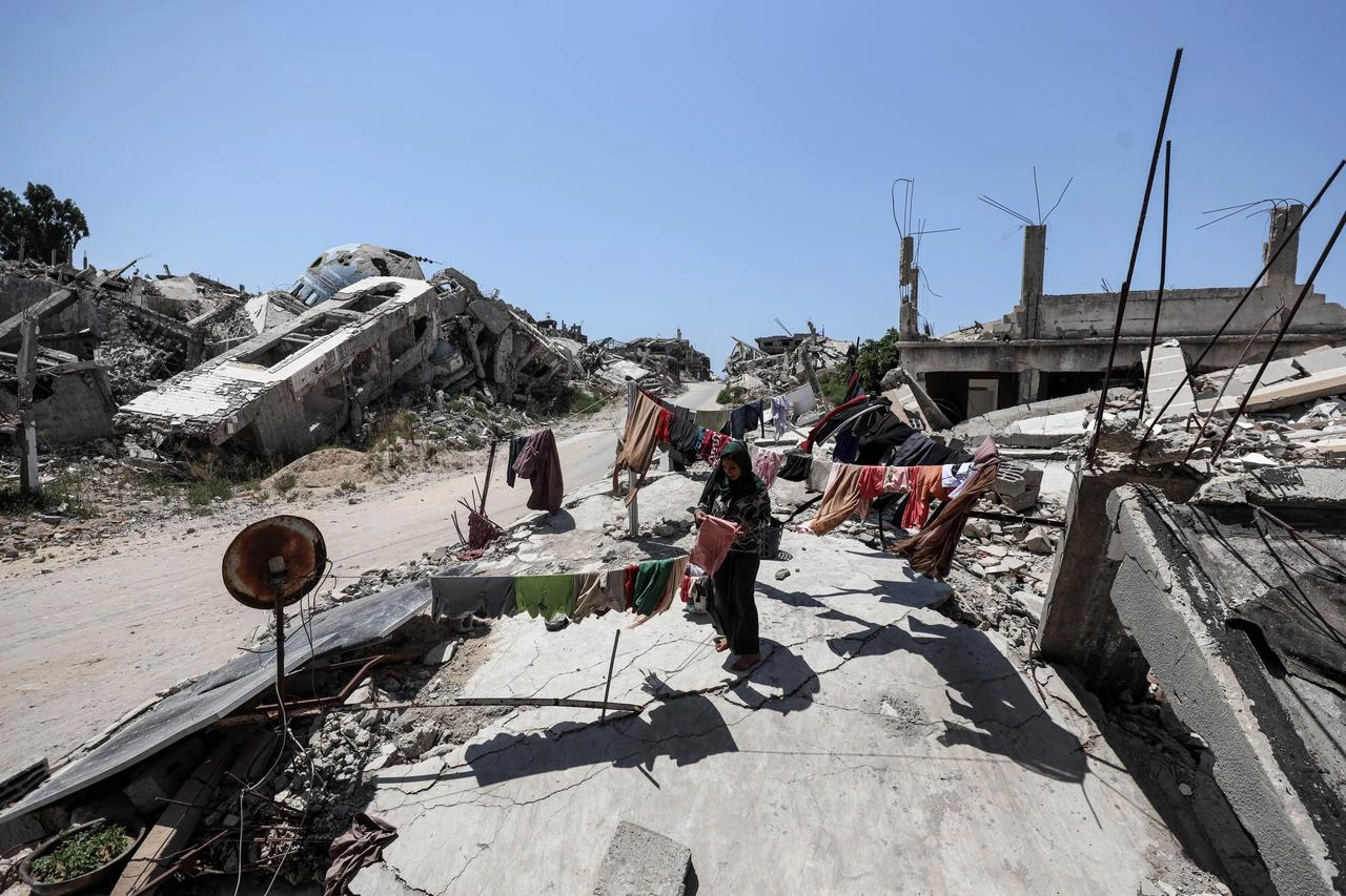 A woman does the laundry as displaced Palestinian families try to survive under challenging conditions amidst the rubble of destroyed buildings following Israeli attacks in Beit Lahia, northern Gaza Strip, Palestine on August 03, 2026. (AA Photo)