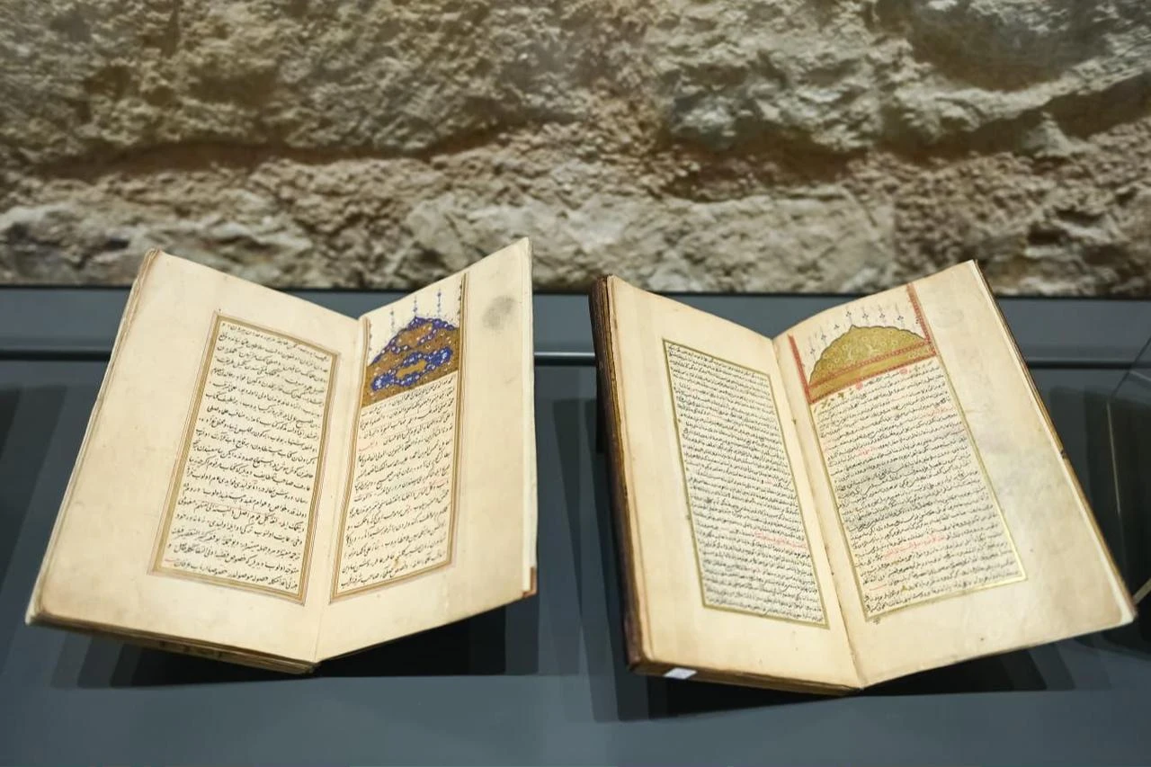 Manuscripts from the Türkiye Manuscript Institution’s collection are presented in a display case in Istanbul, Türkiye, Aug. 3, 2026. (AA Photo)