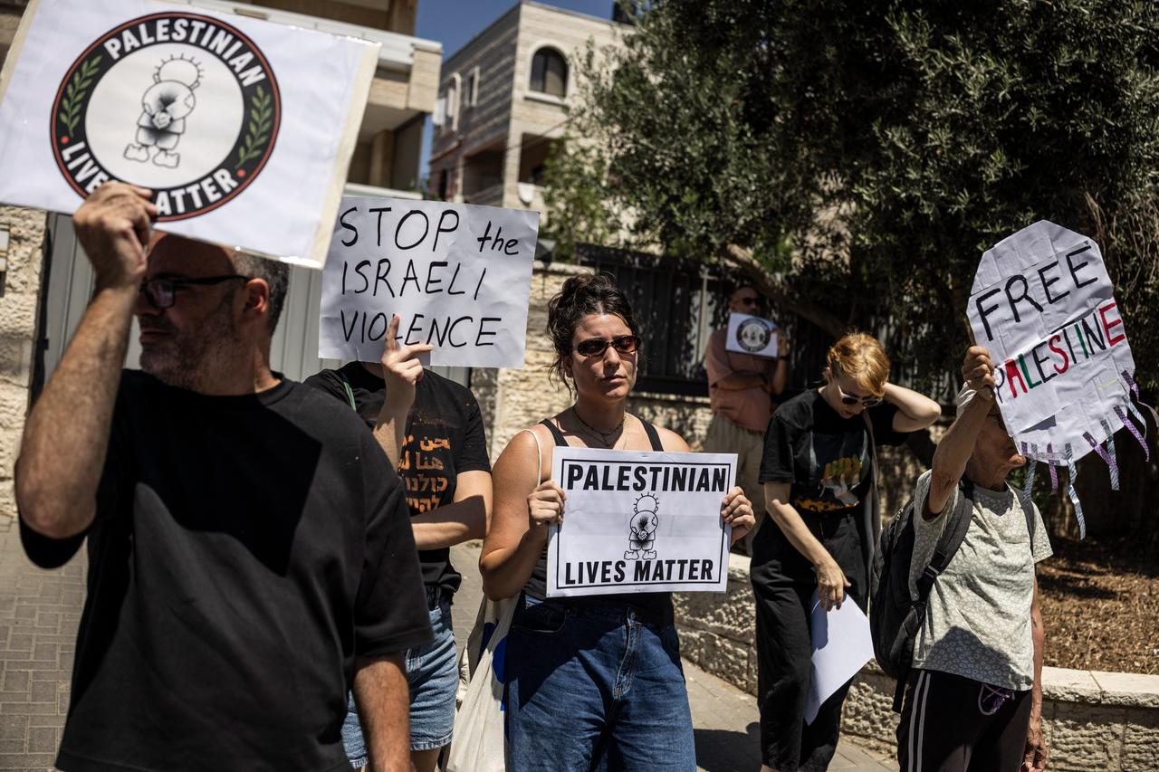 Israeli activists hold up posters as they demonstrate, calling for an end to settler violence, outside the European Union office in Jerusalem on August 28, 2026. (AFP Photo)