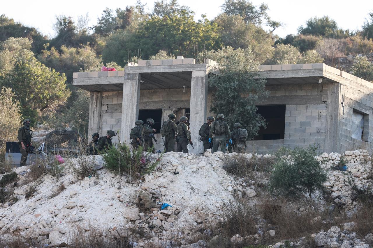Israeli soldiers gather outside a home under construction following a drone strike killing of three Palestinians, on the western outskirts of the northern city of Jenin, in the Israeli-occupied West Bank on August 28, 2026. (AFP Photo)