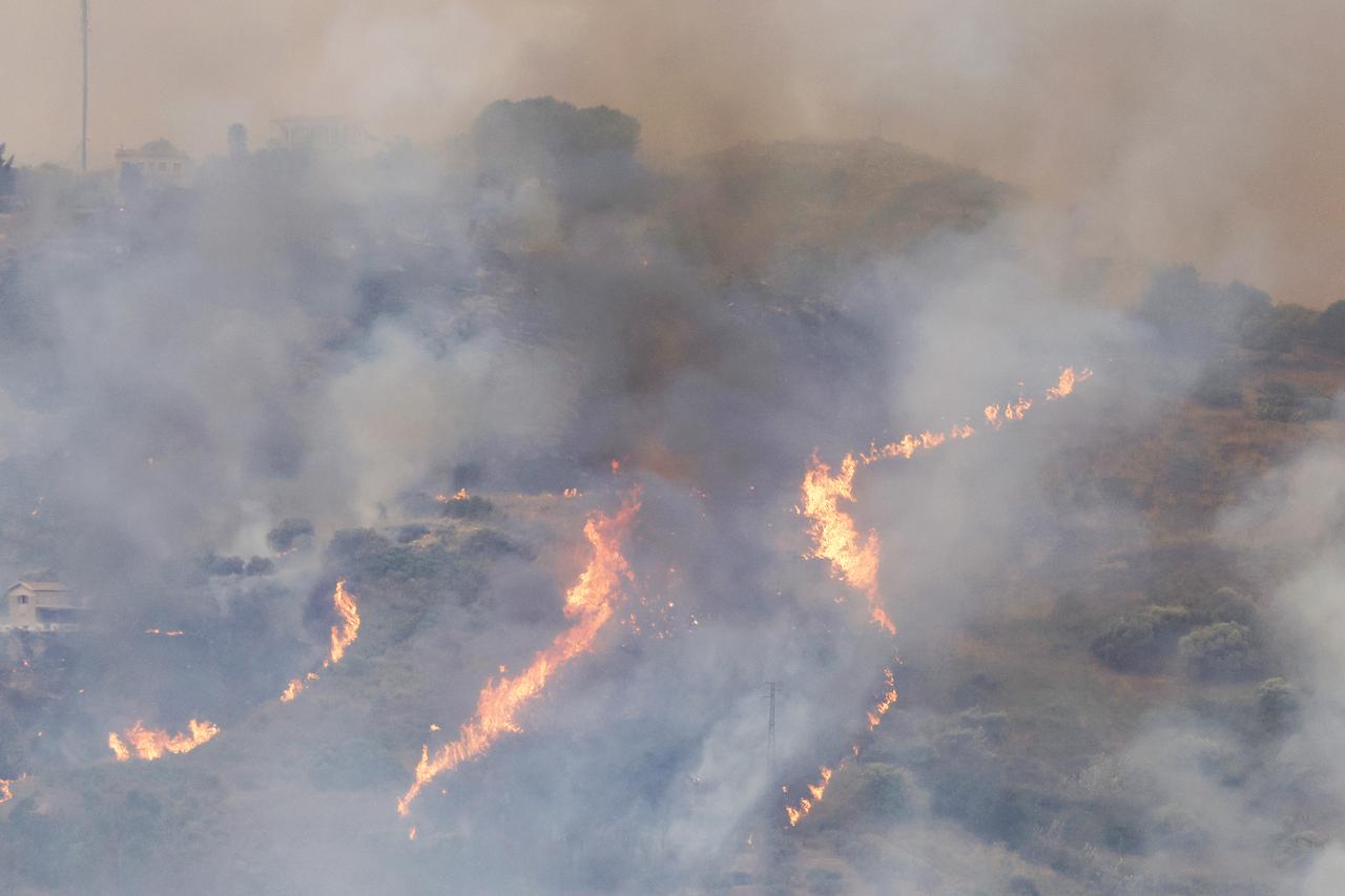 Flames and smoke rise across a hillside as wildfires threaten residential areas near Palermo, Sicily, Italy, Aug. 30, 2026. (AA Photo)