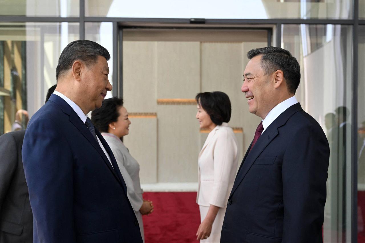 In this handout photograph taken and released by the Kyrgyz Presidential Press Office on August 30, 2026, Kyrgyzstan's President Sadyr Japarov (R) welcomes China’s President Xi Jinping (L) upon his arrival in Bishkek. (Photo by Kyrgyz Presidential Press Office / HO / AFP)