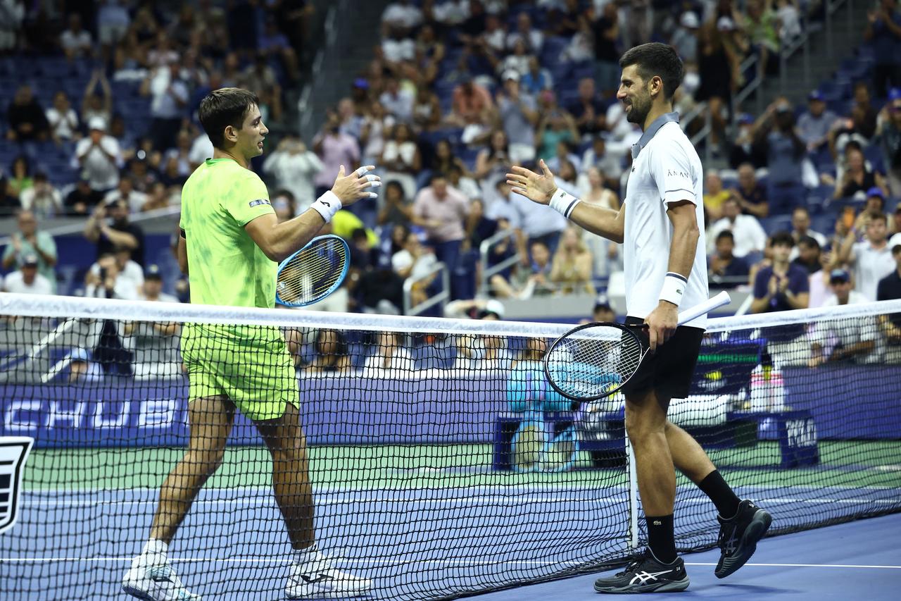 Djokovic (R) congratulates Navone after losing the match on day one of the U.S. Open tennis tournament on August 30, 2026. (AFP Photo)