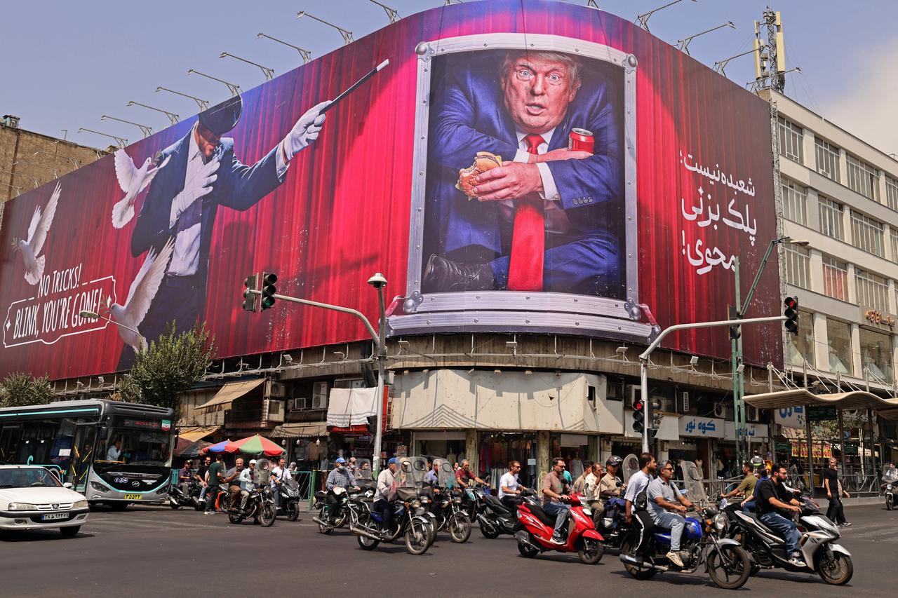 Motorists ride past a billboard depicting US President Donald Trump inside a catering container, installed on a building along a street in downtown of Tehran on August 31, 2026. (AFP Photo)