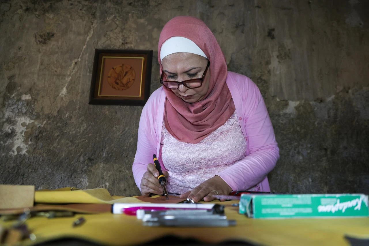 Syrian artisan Yememe Turkmeni works to preserve the traditional art of leather burning, a craft that is at risk of disappearing in Aleppo, Syria, on July 31, 2026. (AA Photo)
