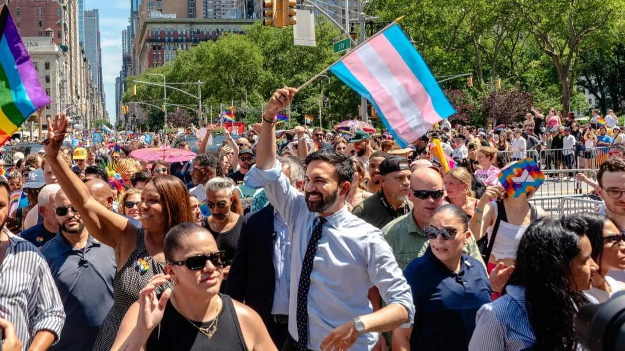 Then-candidate Zohran Mamdani waves a transgender flag on November 5, 2025.