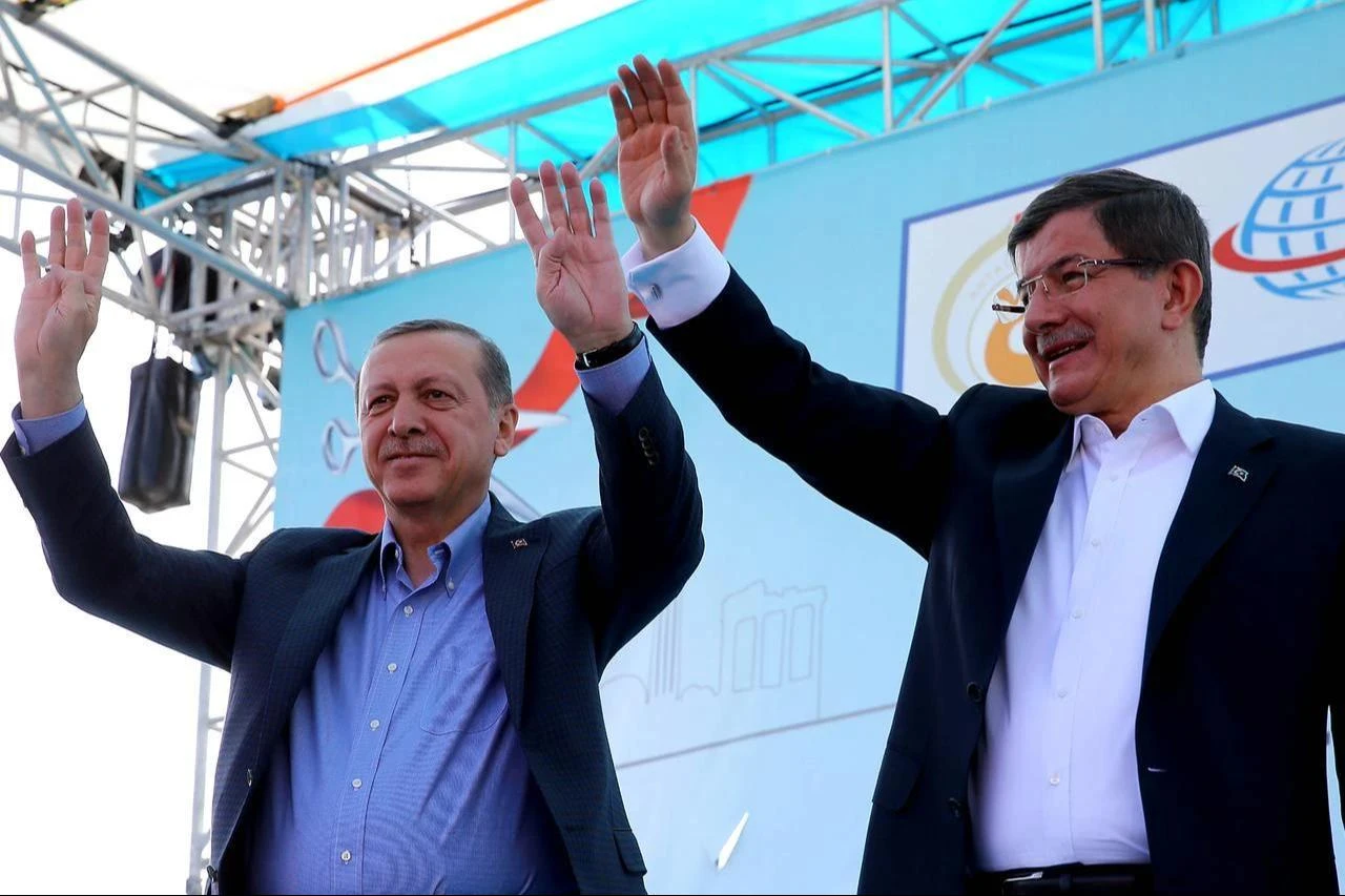 Turkish President Recep Tayyip Erdogan (L) raises his hands with as then-Prime Minister Ahmet Davutoglu (R) waves his hands during an opening ceremony in Kepez district of Antalya, Türkiye on April 22, 2016. (AA Photo)