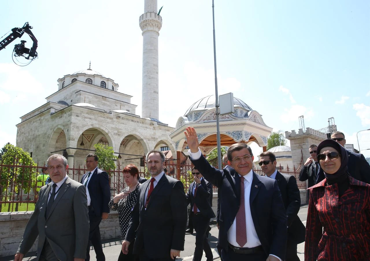 Then-Prime Minister Ahmet Davutoglu (2nd R) waves as he and his wife Sare Davutoglu (R) attend the opening ceremony of Ferhadiye Mosque, demolished during war on May 7, 1993 by Serbians and restored with supports of TIKA in Banja Luka, Bosnia-Herzegovina on May 7, 2016. (AA Photo)