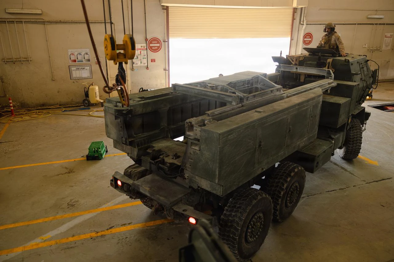 A US Marine guides an M142 High Mobility Artillery Rocket System into a maintenance bay in the US Central Command area of responsibility, June 25, 2026. (Photo via US Marine Corps)