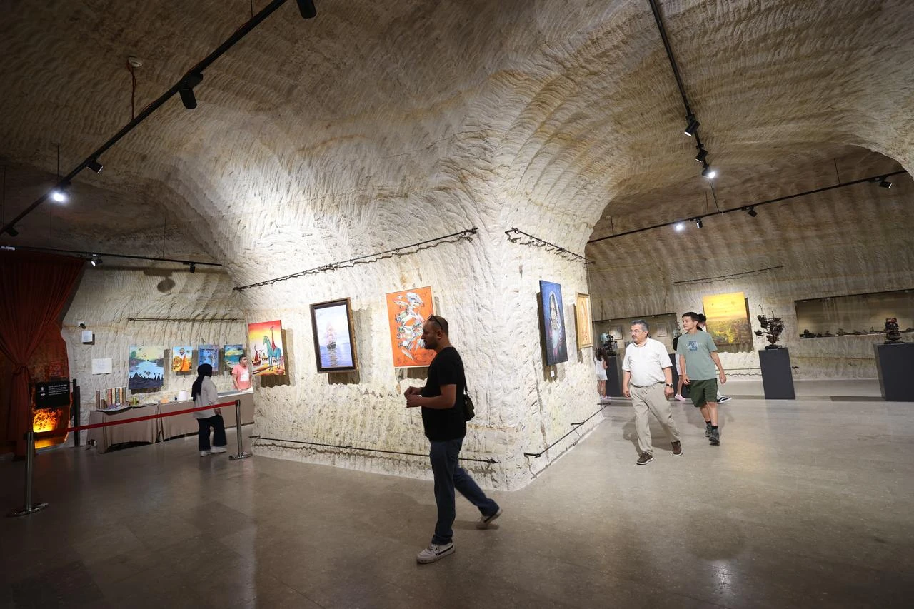 Visitors tour an exhibition inside the Guray Museum’s rock-carved galleries in Avanos, Nevsehir. (AA Photo)