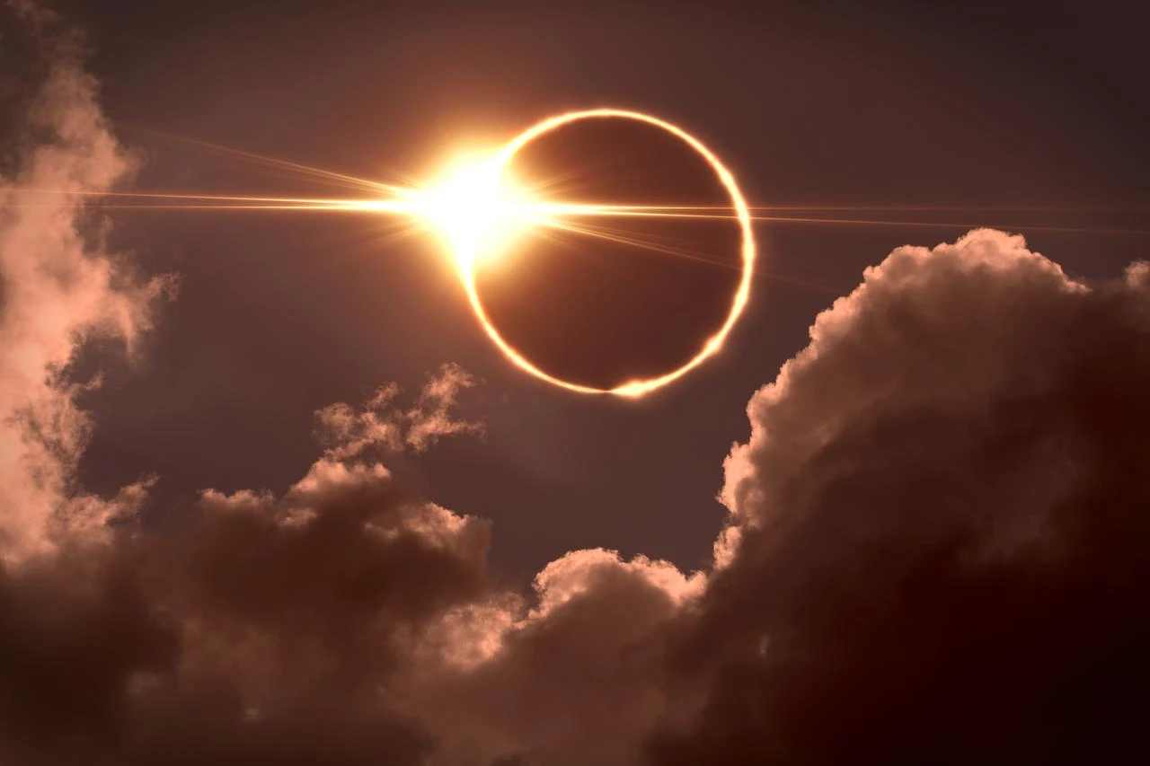 An annular solar eclipse creates a “ring of fire” effect behind clouds. (Adobe Stock Photo)