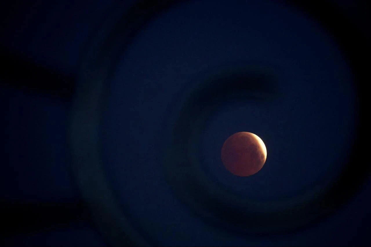A rare  blood Moon  total lunar eclipse is captured near totality from the village of Donon, 40 km from Pontevedra, in northwestern Spain, early on March 14, 2025. (AFP File Photo)