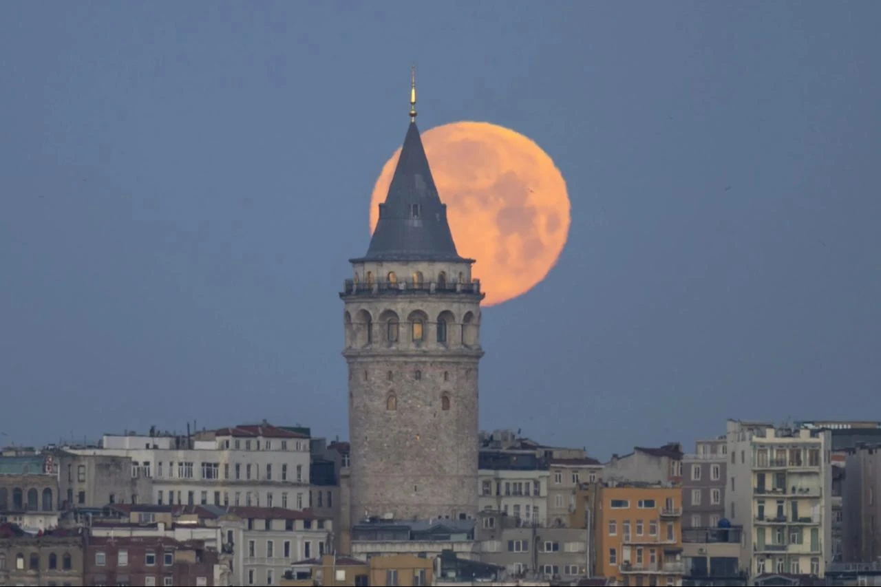 Full Moon rises behind the Galata Tower in Istanbul, Türkiye on March 14, 2025. (AA Photo)