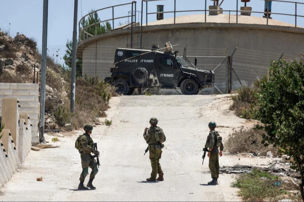 Israeli soldiers patrol the road in the Palestinian village of Tell, in the Israeli-occupied West Bank, July 25, 2026. (AFP Photo)
