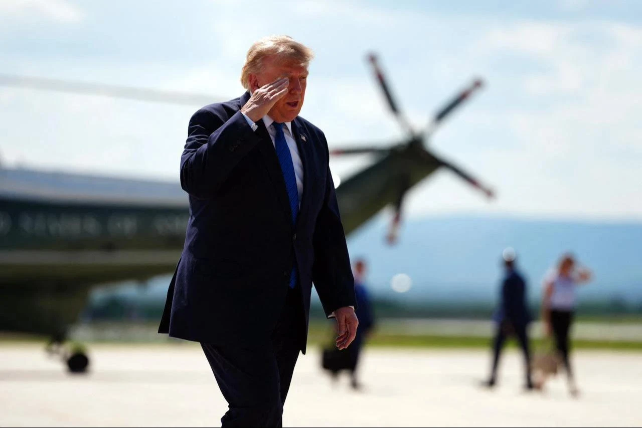 US President Donald Trump salutes before boarding Air Force One while departing Hagerstown Regional Airport in Washington County, Maryland, on July 31, 2026, following a Cabinet meeting at Camp David. (AFP Photo)