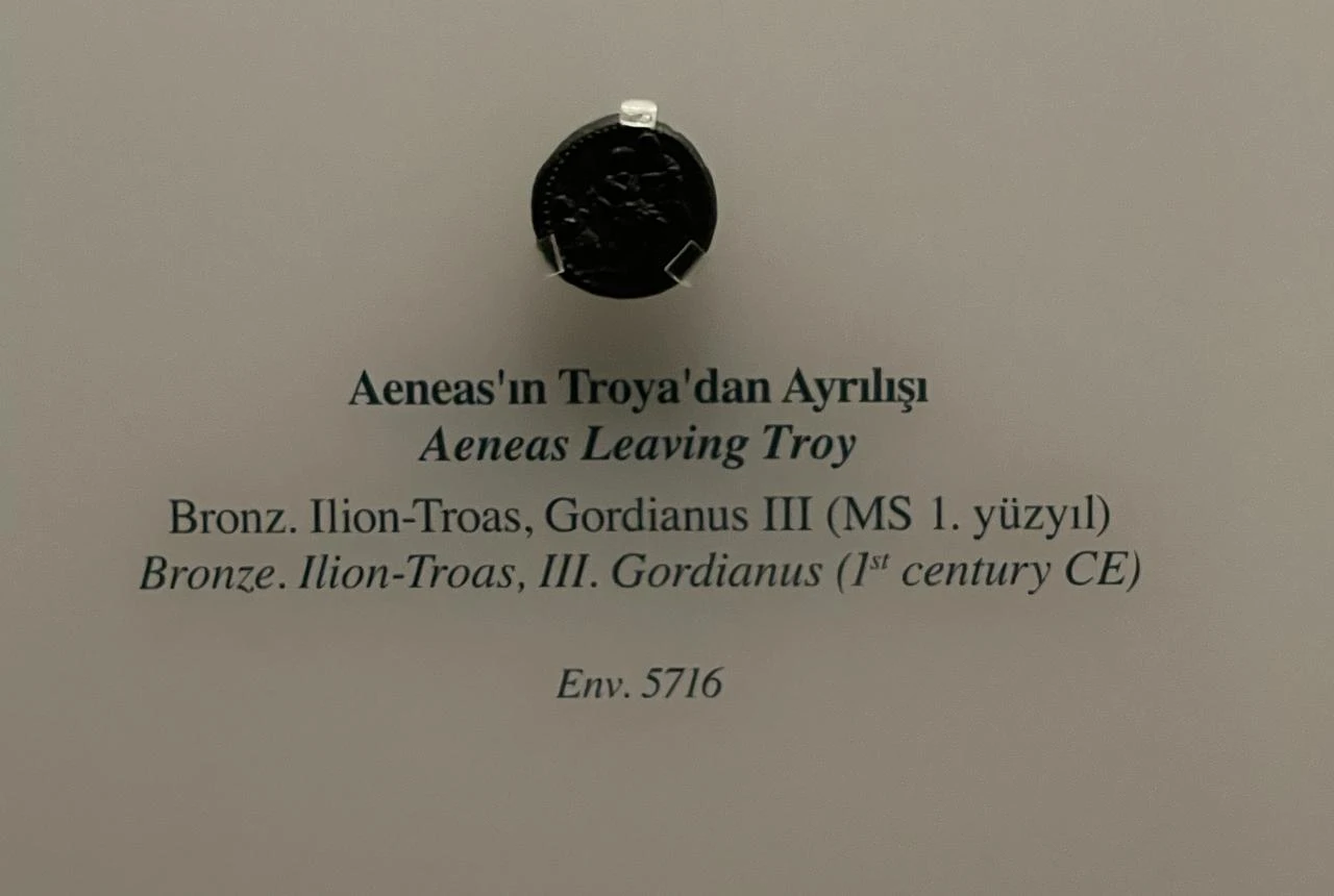 A bronze coin depicting Aeneas leaving Troy is displayed in the Troy galleries of the Istanbul Archaeological Museums, Türkiye. (Photo by Koray Erdogan)