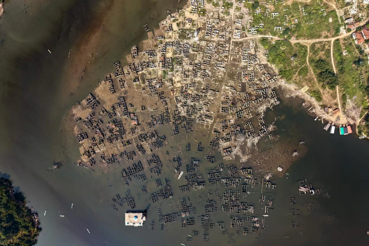 An aerial view taken on July 30, 2026 shows Somang village in Lebak in Indonesia's western Banten province, which was deliberately flooded to make way for the construction and filling of the Karian Dam that opened in 2023 and has now re-emerged due to the El Nino-driven drought. (AFP Photo)