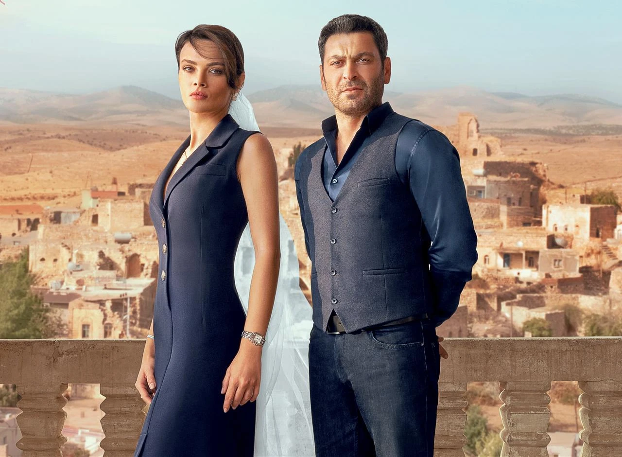 The lead actors of “Uzak Sehir” pose against the historic stone landscape of Mardin, Türkiye. (Photo via Ayna Yapim)