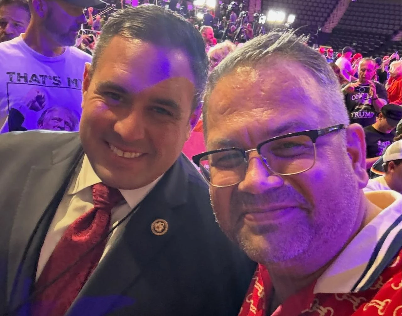 Melih Gogebakan poses with Anthony D'Esposito, U.S. Department of Labor Inspector General, at what appears to be a Trump campaign event. (Photo via Facebook)