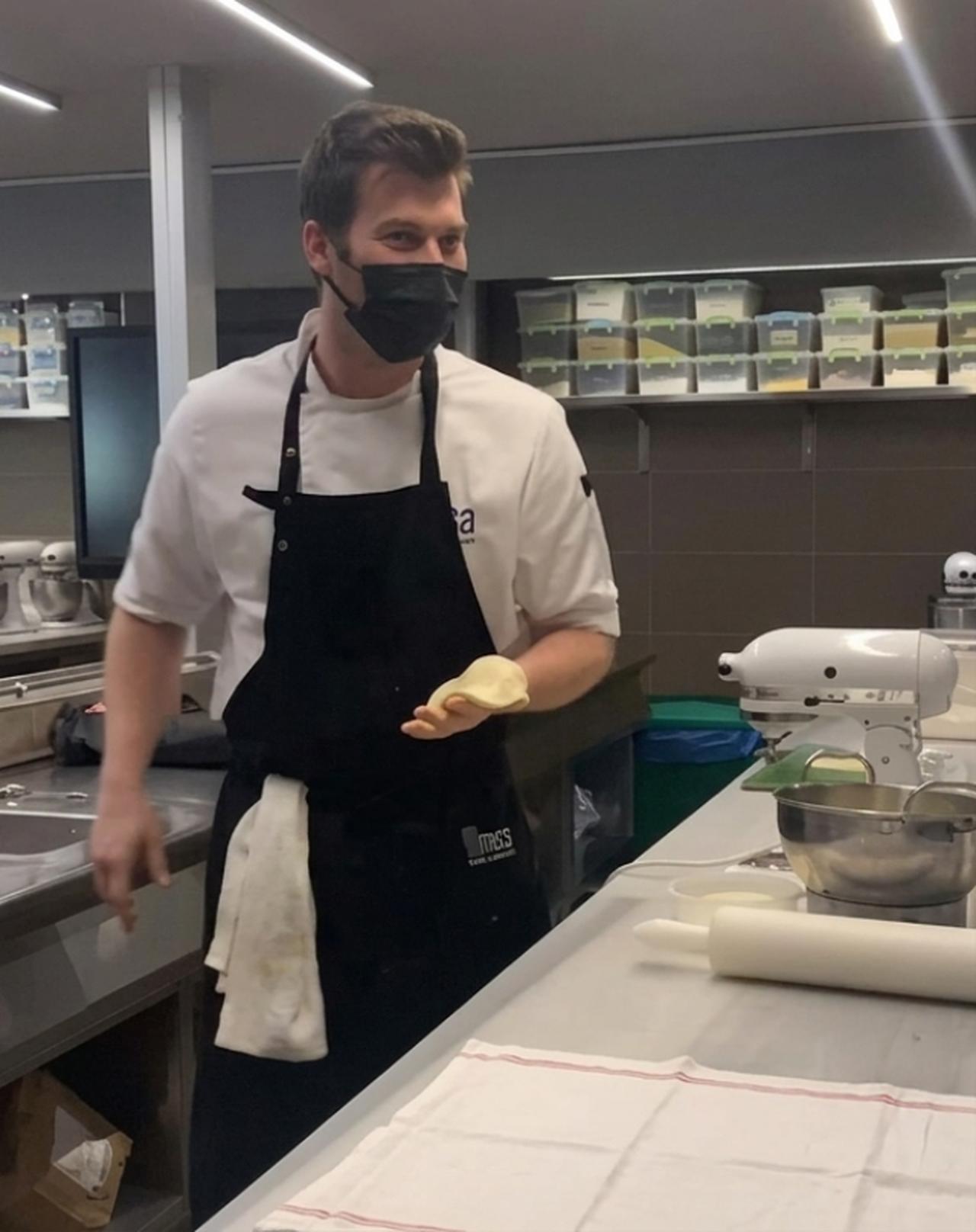 Turkish actor Kıvanç Tatlıtuğ in the kitchen. (Photo via Instagram/devrimholdilakademisi)