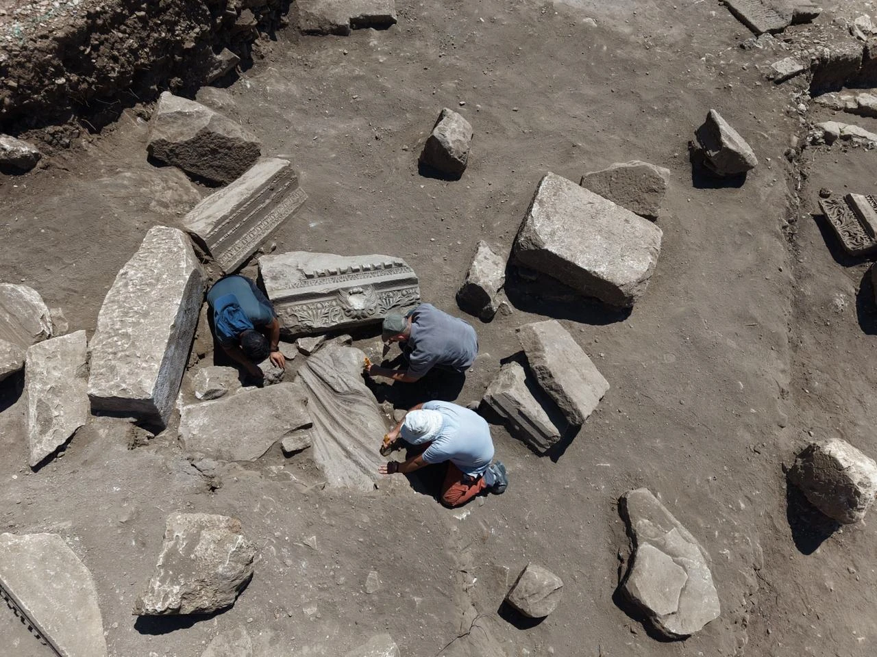 Excavation teams work around the 2.2-meter marble statue group depicting Asklepios and Telesphoros after its discovery among collapsed remains at Aspendos. (AA Photo)