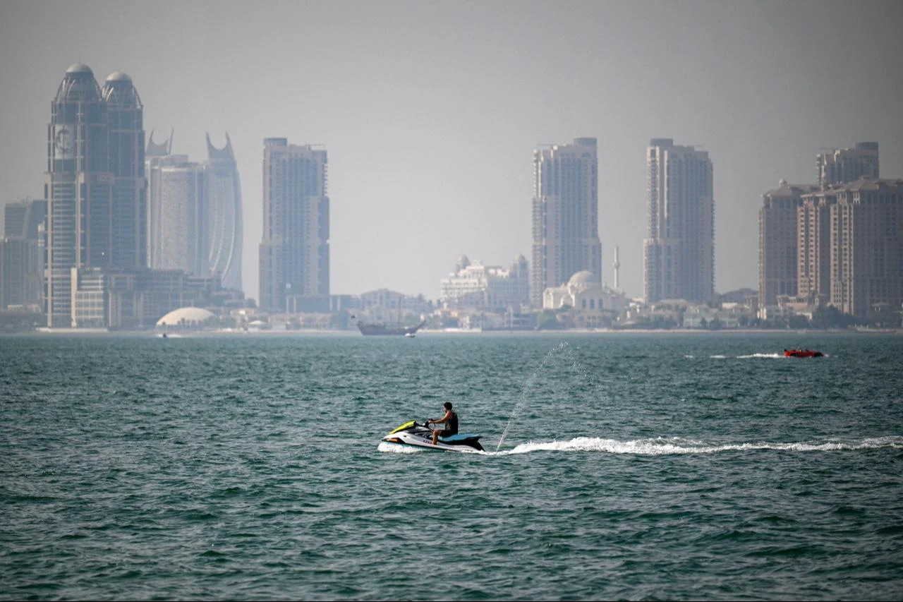 A man rides a personal watercraft in the Gulf waters off of Doha on August 2, 2026. (AFP Photo)