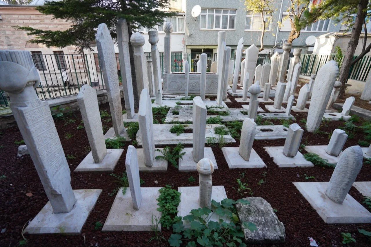 Restored Ottoman-era gravestones stand inside a historic hazire in Istanbul’s Fatih district, Türkiye. (AA Photo)